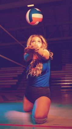 a young woman is playing volleyball on the court