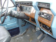 the interior of an old car with wood paneling and dash board, steering wheel and dashboard