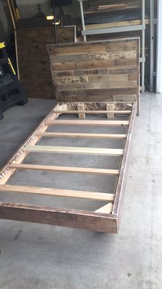 a bed frame made out of wooden planks