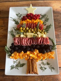 a christmas tree made out of fruits and veggies on a white platter