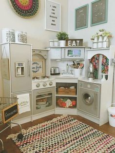 a kitchen with an oven, refrigerator and washing machine in it's cabinet space