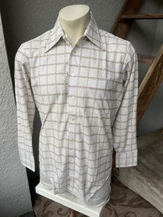 "This genuine, 1980s beige dress shirt has a great geometric print and a wide collar. Excellent condition! Made by Arrow Knits - 65% polyester, 35% cotton. Check the measurements: SIZE:  Pit to pit: 21.5\" Collar to hem: 30\"  Sleeves: 25\"  The tag says  medium 15.5 33.  Check the measurements. The male mannequin would be about 5'10\", 175 lbs. ITEM 744" Classic Patterned Long Sleeve Shirt, Classic Long Sleeve Patterned Shirt, Formal Collared Patterned Shirt, White Collared Shirt With Geometric Pattern, Long Sleeve Shirt With Geometric Pattern For Spring, Retro White Long Sleeve Shirt, Vintage Patterned Long Sleeve Shirt, Vintage Long Sleeve Patterned Shirt, Fitted Beige Long Sleeve Shirt