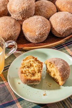 a plate with some muffins on it next to a cup of tea