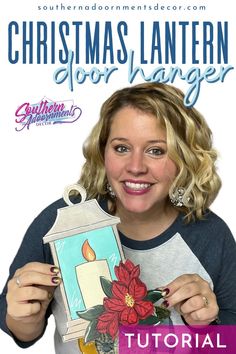 a woman holding up a christmas lantern with the words, christmas lantern floor hanger