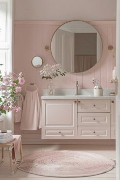 a bathroom with pink walls and flooring is pictured in this image, there are flowers on the rug next to the sink