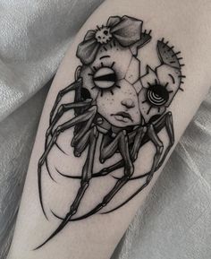 a black and white image of a spider with flowers on it's back leg