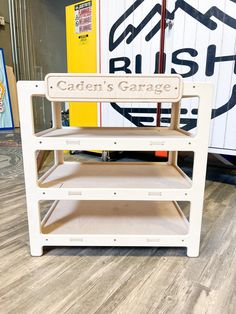 a wooden sign that says garden's garage on the side of a shelf in a store