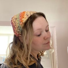 a woman wearing a multicolored crocheted headband