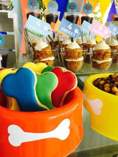 cupcakes and other treats are on display at a dog themed birthday party for children