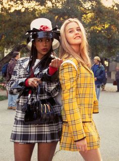 two women in plaid outfits walking down the street