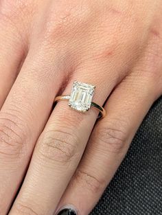 ✥ This breathtaking 2.50CT Emerald Cut Hidden Halo Lab Grown Diamond Engagement Ring is the epitome of minimalist elegance. The emerald cut diamond, known for its timeless appeal and mesmerizing clarity, is perfectly complemented by a hidden halo, adding a touch of sparkle from every angle. This sophisticated design makes it a standout choice for those seeking a refined yet modern look. We also offer 3.0CT and 3.50CT options to match your preferred size. Contact us for any custom size requests. "Enhance your eco-friendly journey with conflict-free, timeless handmade lab-grown diamonds." ✦ Main Stone Details✧ Shape: Emerald Cut Lab Grown Diamond✧ Weight: 2.50CT | 3.0CT | 3.50CT✧ Color: EF✧ Clarity: VS1-VS2✧ Authenticity: IGI Certified Diamonds ✦ All CVD lab-grown stones come IGI certified, Emerald Cut Hidden Halo, Open Gallery, Lab Grown Diamond Engagement Ring, Hidden Halo, Emerald Cut, Diamond Engagement Ring, Statement Ring, Low Profile, Lab Grown