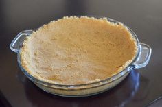 a pie crust in a glass dish on a table