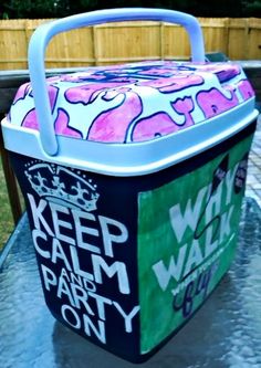 a cooler sitting on top of a table with the words keep calm and party on