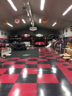 a garage filled with lots of different types of cars in it's flooring