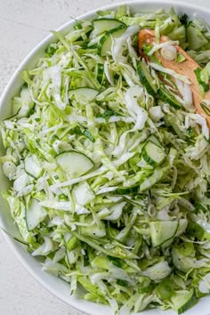 cabbage salad in a white bowl with the words make this cabbage salad on it's side