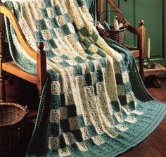 a crocheted blanket sitting on top of a wooden chair