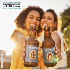 two women holding beer bottles in their hands