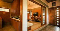 the inside of a house with wood trimming and large mirror on the wall above it