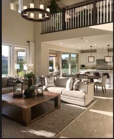 a living room filled with furniture next to a stair case in front of a window