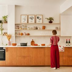 a woman standing in front of a kitchen counter