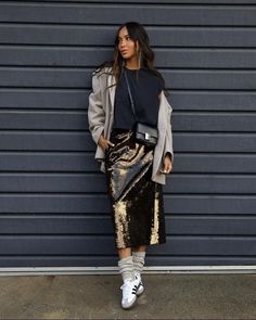 Shine bright this party season with these 21 sparkly sequin skirt outfits, perfect for both casual and dressy looks. ​ ​You'll find gorgeous ideas like this one with a long gold sequin skirt, a black tee, and Adidas Samba sneakers, that'll make you the star of any Christmas or New Year's Eve party.