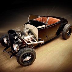 an old model car is parked on the wooden floor