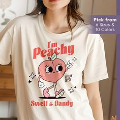 This Retro Peach Mascot shirt is everything you've dreamed of and more. It feels soft and lightweight, with the right amount of stretch. It's comfortable and flattering for all. This graphic tee makes a perfect shirt for travel, at home, or anywhere you go, and it makes an ideal gift for yourself or your loved ones. See more of our shirt collection: https://www.etsy.com/shop/JoonStudioCo?ref=seller-platform-mcnav&page=1#items + ~ + ~ + ~ + ~ + ~ + ~ + ~ + ~ + ~ + ~ + ~ + ~ + ~ + ~ + ~ + ~ + ~ + Trendy Peach T-shirt With Letter Print, Cute Peach T-shirt With Crew Neck, Casual Peach T-shirt With Letter Print, Trendy Peach Top With Graphic Print, Trendy Peach Relaxed Fit T-shirt, Trendy Relaxed Fit Peach T-shirt, Peach Crew Neck Top With Graphic Print, Peach Relaxed Fit T-shirt With Letter Print, Relaxed Fit Peach T-shirt With Letter Print