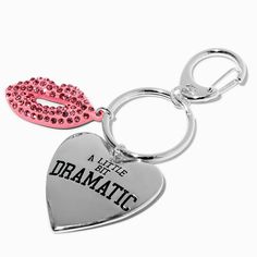 two heart shaped key chains with pink and black beads on them, one has the words'a little bit dramatic '