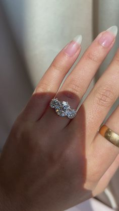 a woman's hand with two rings on it and one ring in the middle