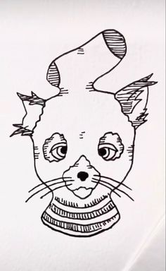 a black and white drawing of a cat's face