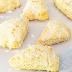 glazed scones are sitting on a baking sheet