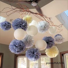 some paper flowers are hanging from the ceiling