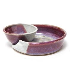 two ceramic bowls sitting on top of each other