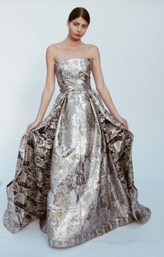 Metallic brocade ball gown gown with cathedral train. Swoop strapless bodice features adjustable lattice-wrapping sashes that cinch and corset the waist, tying into an oversized bow over a dramatic open back. Fully lined. Zipper back. Bodice features full boning for support and structure. For order inquiries and questions, contact Contact Us! Brocade Gown, Brocade Coat, Gold Wedding Gowns, Holy Matrimony, Cathedral Train, Ball Gown, Lattice, Fashion Ideas, Open Back