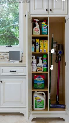 an open cabinet with cleaning products in it