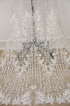 This Stunning Luxury High quality Embroidered Lace Fabric design piece has soft hand feel, ideal for use in DIY craft projects, wedding dress, clothing, party dress, dolls outfits, curtains, shams, lamp shades, headpieces, costumes, accessories, Apparel, handcraft Accessory, cake decor, unity candle, garters, headbands, dance costumes, belly dance costumes. --- THE DETAILS --- This listing is for 1 yard embroidery lace fabric. Wide: about 51inch/130cm Colors: off-white Material: Polyester, Trans White Sequined Wedding Dress For Banquet, White Embellished Embroidered Fabric For Banquet, Wedding Sequined Embroidered Floor-length Fabric, Wedding Embroidered Sequins Floor-length Fabric, Floor-length Embellished Sequin Fabric For Weddings, Floor-length Embroidered Fabric With Sequins For Wedding, Floor-length Embroidered Wedding Fabric With Sequins, White Embroidered Fabric For Party, Floor-length, Wedding Floor-length Embroidered Fabric With Sequins