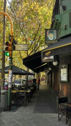 the street is lined with tables and umbrellas