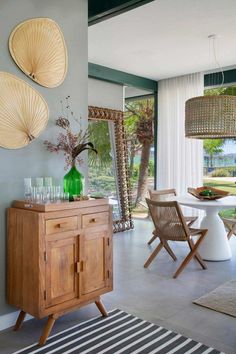 a dining room table and chairs in front of a large window