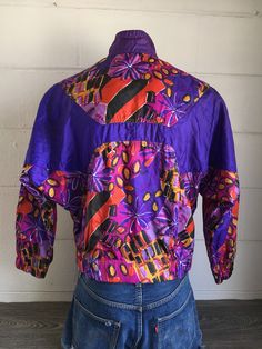 Get wild and whacky in this 90's gem! It screams hip hop, street style, and funky fun! There is a small mark on the sleeve (see pic) otherwise mint condition. Check out other sensational vintage Nike gear in my shop https://www.etsy.com/shop/sweetVTGtshirt?section_id=11916484&ref=shopsection_leftnav_4 Label: Nike Measurements (inches): Chest/Bust: 24 Bottom hem: 19 (unstretched) Sleeve (from collar): 28 1/2 Total length from shoulder to bottom seam: 24 1/2 Size: Tag reads Small. See measurem Vintage Spring Sports Windbreaker, Retro Purple Windbreaker For Streetwear, Vintage Purple Windbreaker For Streetwear, Retro Track Jacket For Spring Sports, Retro Spring Track Jacket For Sports, 1993 Tshirt, Nike Air Jacket, Hip Hop Street Style, Grunge Tee