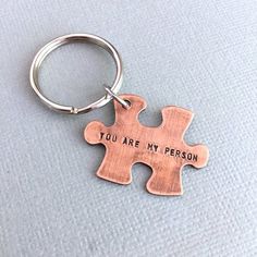 a metal keychain that says you are my person with a puzzle piece on it