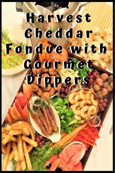 a table full of food with the words harvest cheddar fondue with gourmet dippers