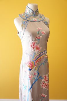 Get all the things you want in this cheongsam dress for your Chinese wedding. Comes with stunning hand embroidery of both the phoenix and peacock symbols--traditionally found on a Chinese wedding dress. This dress can be customized to your measurements as well as length. Have another design in mind? We also do bespoke designs based on your preferences and style--please check out www.eastmeetsdress.com. ✨Check out our additional dresses at www.eastmeetsdress.com✨ The Details: * Silk fabric * Beau Sleeveless Spring Wedding Cheongsam, Spring Wedding Sleeveless Cheongsam, Traditional Summer Wedding Cheongsam, Fitted Sleeveless Embroidered Wedding Dress, Traditional Sleeveless Silk Dress, Floral Print Fitted Cheongsam For Wedding, Floral Fitted Cheongsam For Wedding, Fitted Floral Cheongsam For Wedding, Sleeveless Embroidered Silk Dress