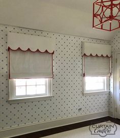 an empty room with white walls and polka dot wallpaper on the walls, two windows in the center