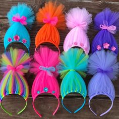 there are many different colors of hair on the table with each one's headbands