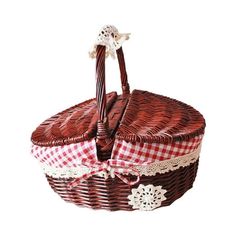 a wicker picnic basket with red and white checkered cloth on the bottom, holding two small baskets