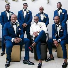 a group of men in suits posing for a photo