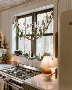 a kitchen with a stove top oven next to a window