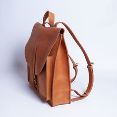 Compact and stylish backpack made of premium-quality vintage leather. You can wear it with both sneakers and a dress. The backpack is universal — suitable for any occasion. Classic shape will appeal to both men and women. Inside, there is a full-width leather pocket that can fit a laptop. Additionally, there are two extra pockets for small items. Two spacious front external pockets are fastened with metal buttons. Adjustable straps allow you to customize the backpack to your height. You can choo Casual Leather Backpack With Leather Lining, Modern Leather Backpack For School With Leather Handles, Casual Leather Backpack With Waxed Finish, Vintage Backpack With Leather Lining For Everyday Use, Modern Everyday Backpack With Waxed Finish, Casual Backpack With Leather Lining For Everyday, Vintage Everyday Backpack With Leather Backing, Casual Backpack With Leather Backing, Everyday Leather Backpack With Waxed Finish