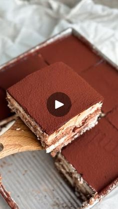 a piece of cake being cut with a wooden spatula