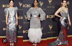 three women in silver dresses on the red carpet